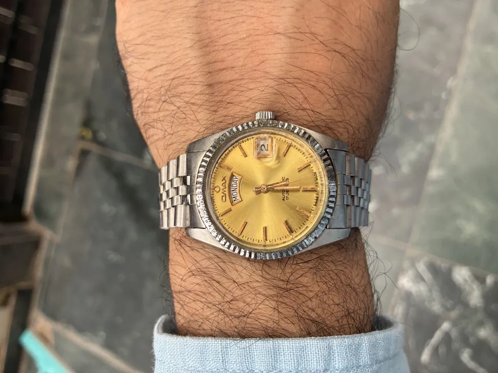 Buy used OMAX Day Date Automatic Swiss Watch Gold Dial Silver Case online on Resellpur